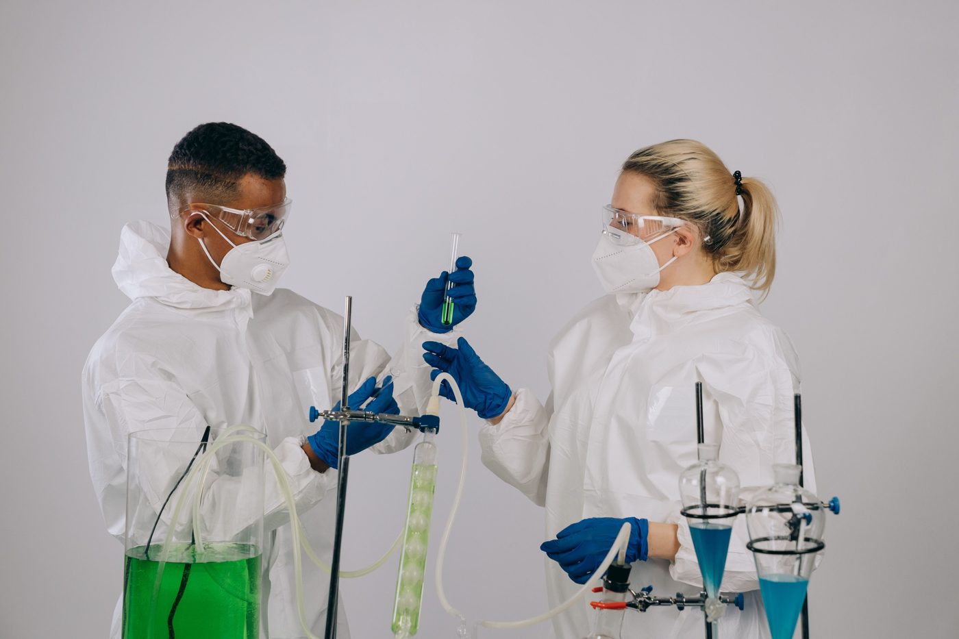 Researchers handle samples and equipment in a laboratory.