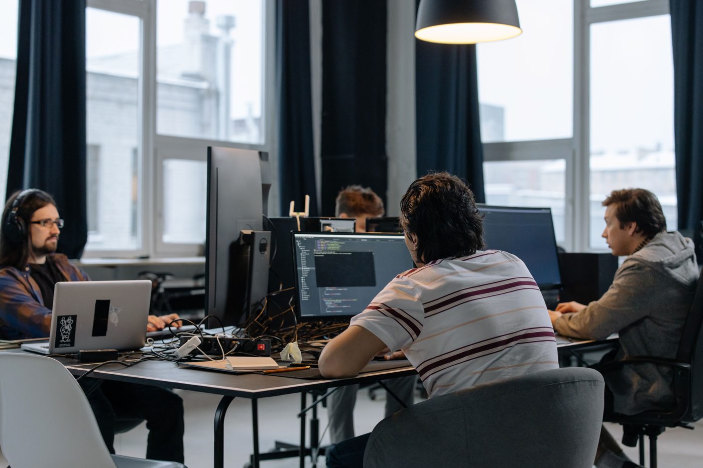 Developers work at computer workstations.